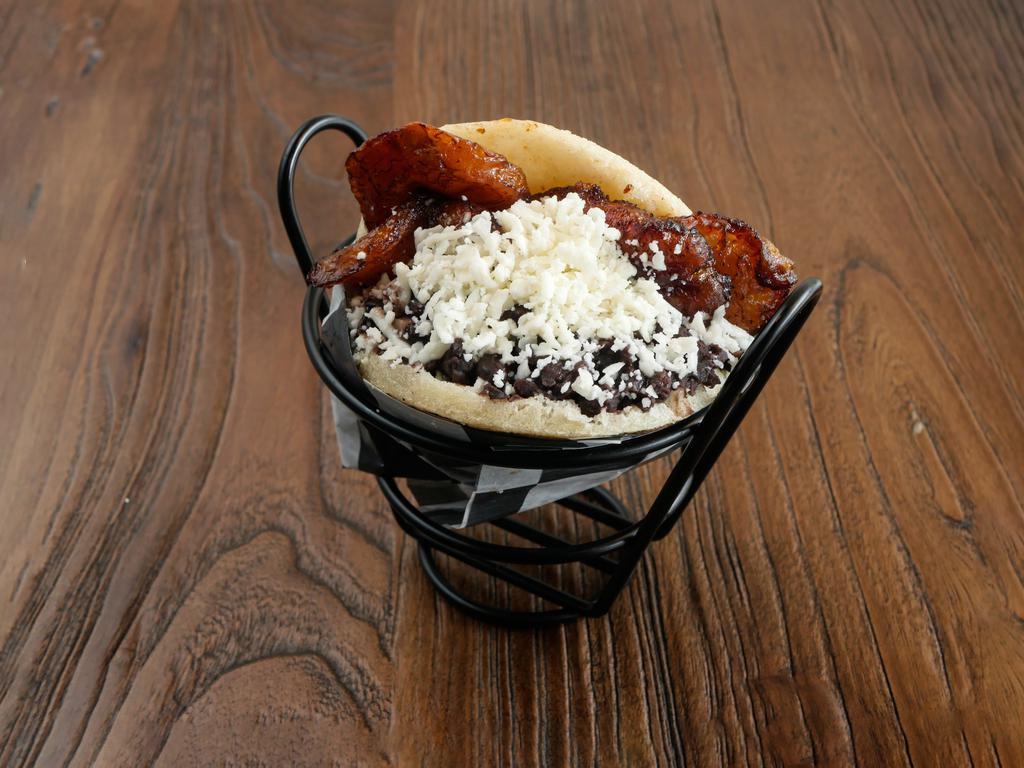 Orinoco Arepa (V) · Grilled corn dough patty (arepa) filled with black beans, sweet plantains, and grated white cheese.