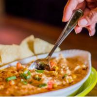 Crawfish Boil Queso · A creamy queso filled with Louisiana crawfish tails, onions, celery, garlic, and lots of spi...