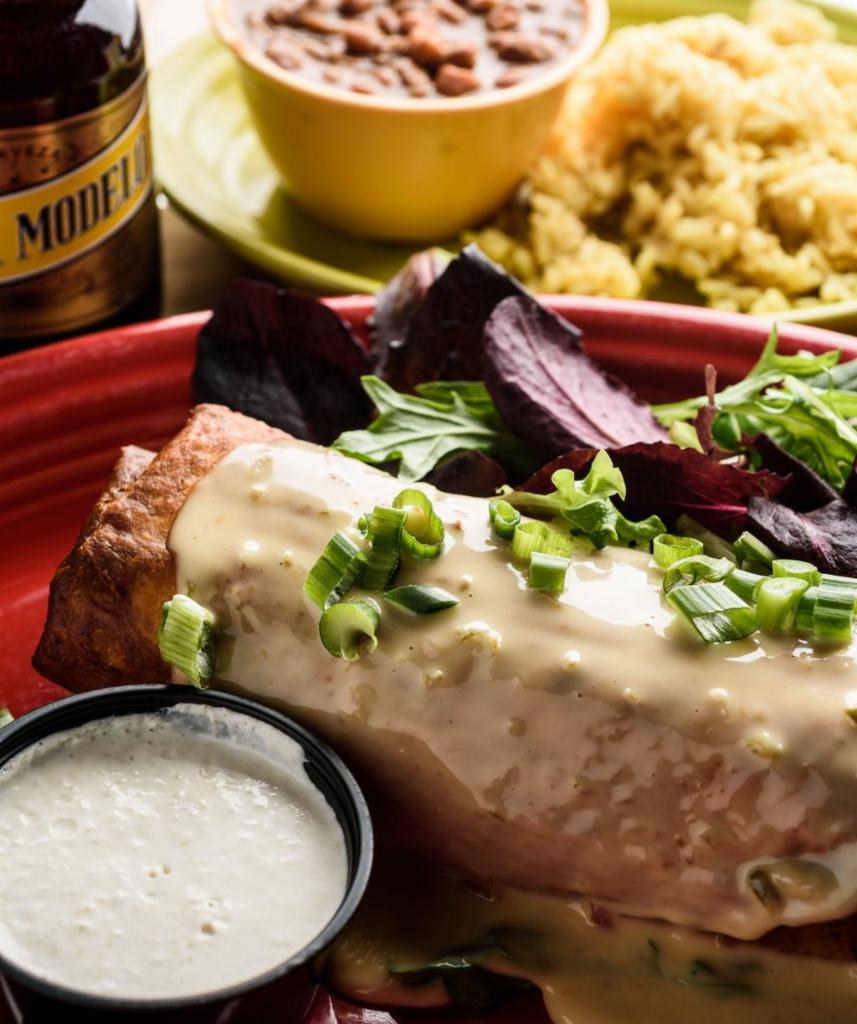 Chimichanga with 2 Sides · Deep-fried burrito filled with house-smoked brisket, rice, black beans and topped with queso sauce. Served with horseradish dipping sauce.