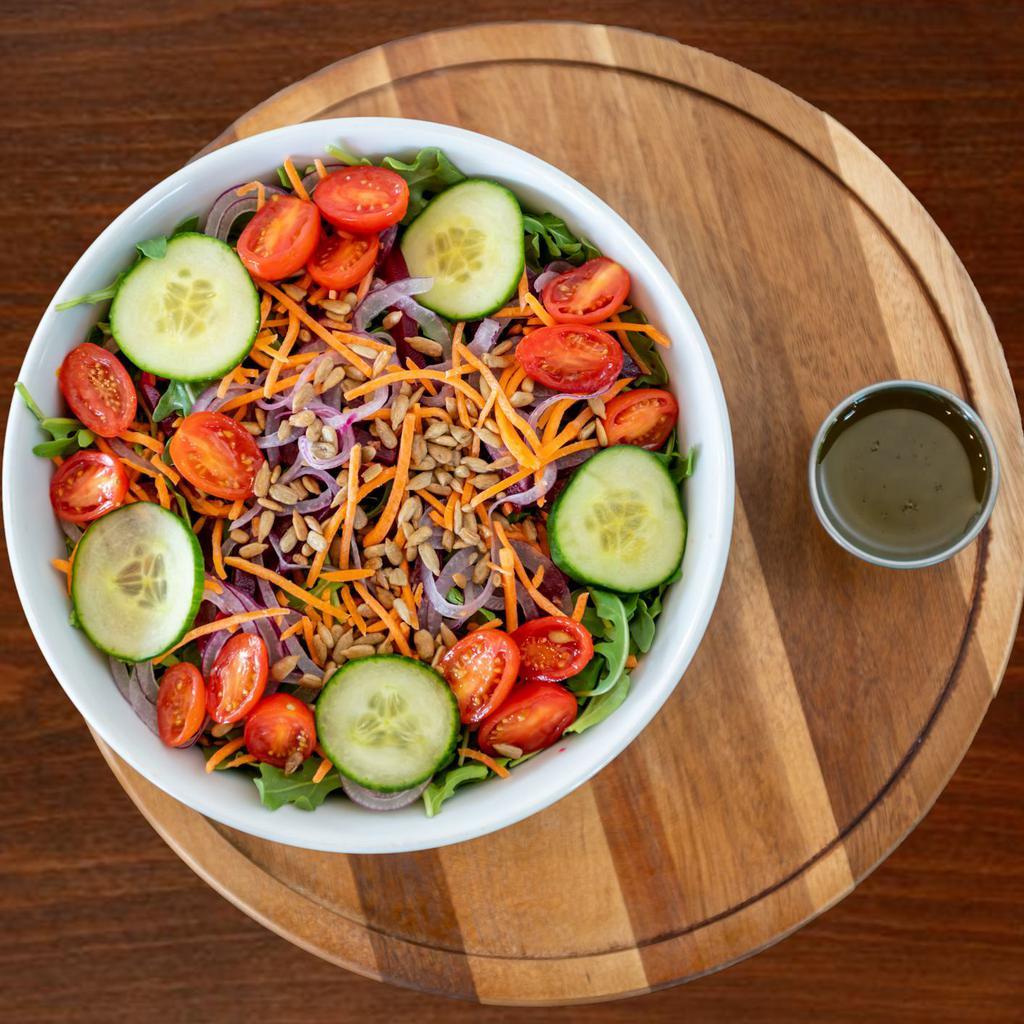 Plum Beach Garden Salad · Romaine, baby arugula, yellow plum tomatoes, beets, red onion, sliced cucumber, carrots, sunflower seeds and Shayna's dressing.