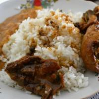 Pollo Guisado · Chicken stew. Served with rice and beans.