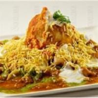 Samosa Chaat  · Street style. Smashed samosa, topped with red onions, garbanzo beans, tamarind and mint chut...
