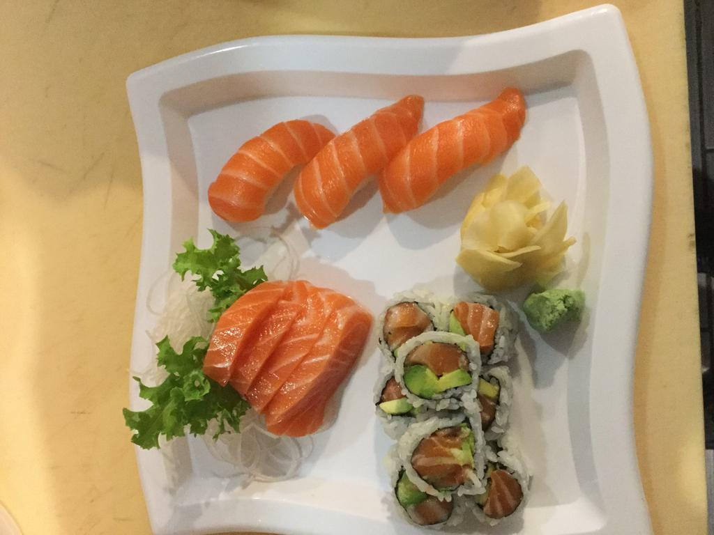Salmon Lover · 3 pieces salmon sushi, 4 pieces salmon sashimi and spicy salmon avocado roll. Raw.