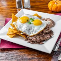 Asada Chilaquiles  · Crispy Corn Tortilla chips,Our homemade habanero sauce,refried beans, two sunny eggs, carne ...