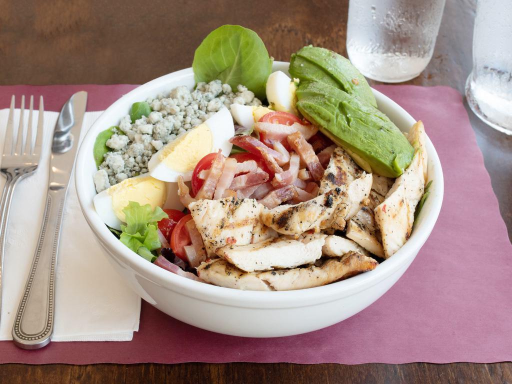 Cobb Salad · Mixed greens, grilled chicken, avocado, cherry tomatoes, boiled egg, bacon, blue cheese and red wine vinaigrette.