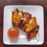 Whiskey Wings · Bourbon, honey and habanero with apricot relish. 7 per order.