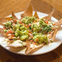 Nachos Azteca · Tortilla chips with beans, melted cheese, guacamole and pico de gallo.