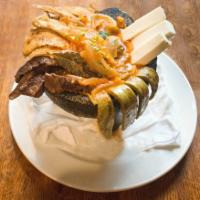 Molcajete Surtido · Grilled Slices of Skirt Steak, cactus pedals, and chicken breast, flavored with chorizo. Ser...
