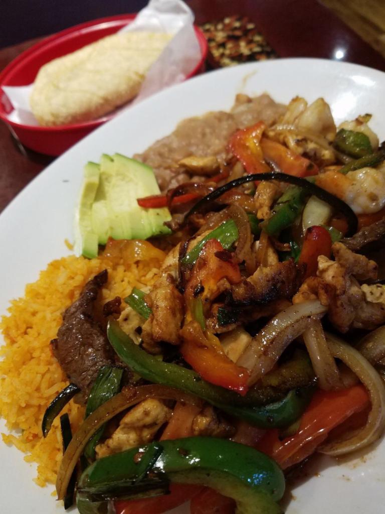 Las Fuentes Fajitas · Seasoned Chicken, Steak, or Shrimp Slices sauteed with chile poblano, red and green bell pepper, chopped garlic, onion and tomato, also with beans and rice and guacamole.