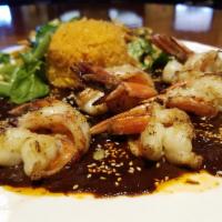 Camarones En Mole Poblano · Black tiger shrimp prepared with our garlic salsa, covered with nut-thickened mole poblano s...