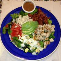 Cobb Salad · A tossing of red leaf lettuce with chicken, bacon, avocado, eggs, crumbled blue cheese, toma...