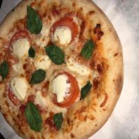 Margarita Pizza · Topped with marinara sauce, mozzarella cheese, sliced tomato, fresh garlic, fresh basil and ...