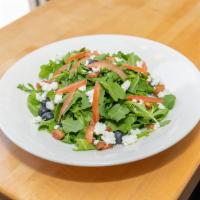 Arugula Salad · Salad with berries, honey roasted walnuts, and goat cheese, house raspberry vinaigrette.