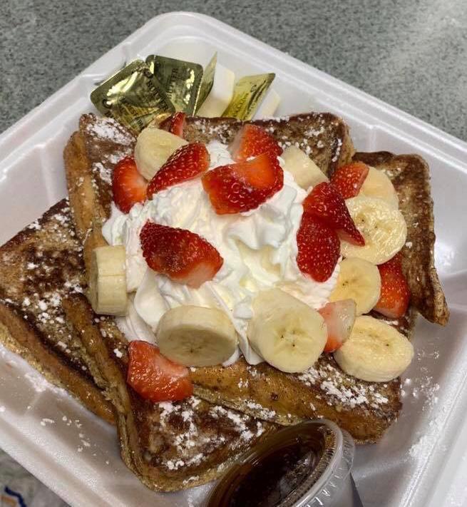 Country French Toast · 3 slices of French toast topped with fresh fruit and whipped cream.