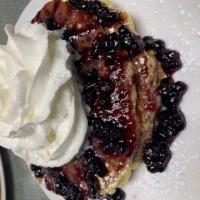 Double Blueberry Pancakes · 3 buttermilk pancakes filled with Blueberries, blueberry compote, whipped cream on top. serv...