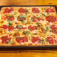 Grandma's Pizza · Just like Grandma used to make! A thin crust, pan-baked pizza with a whole peeled tomato sau...