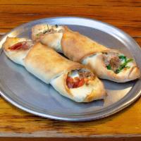 Sausage and Broccoli Rabe Stromboli · Individual pizza dough, stuffed, rolled and baked. Made to order but worth the wait.