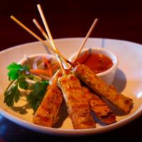 Satay Chicken  · Chicken skewers marinated in Thai spice, grilled and served with peanut sauce and cucumber s...