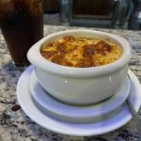 French Onion Soup  · Topped with melted provolone.