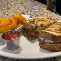 Reuben Sandwich Lunch · Thinly sliced corned beef on grilled rye with sauerkraut and Swiss cheese. Served with a sid...