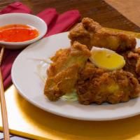 Chicken Wings · Cooked wing of a chicken coated in sauce or seasoning.