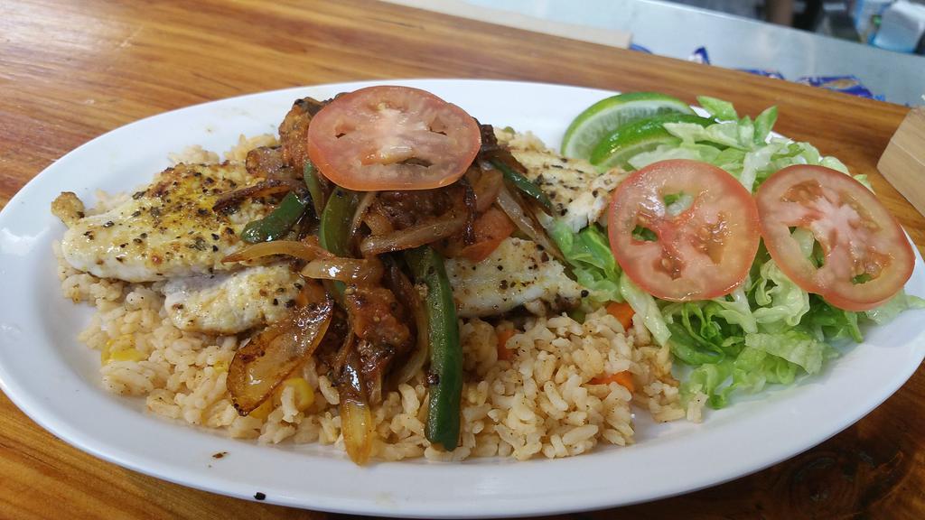 Tilapia Fillet · Choice of either blackened or spicy mango sauce tilapia fillet served on a bed of rice and surrounded by a garden salad garnished with avocado and sliced radish