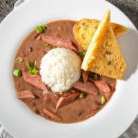 Red Beans ＆ Rice · Simmered red beans and smoked Andouille sausage served on a bed of your choice of white or d...
