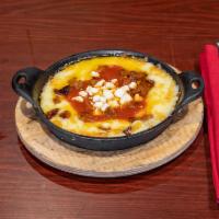 Queso Fundido · Melted cheese, chorizo, ranchero sauce and 2 flour tortillas.