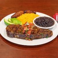 Carne Asada · Thin New York steak marinated with pico de gallo and avocado with sweet plantains.
