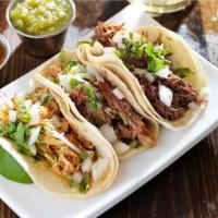 Barbacoa Taco · Slow cooked beef marinated in Mexican spices with fresh cilantro, onions and salsa fresca