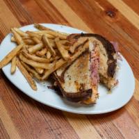 Imperial Reuben Sandwich · Thinly sliced corned beef brisket, Swiss cheese, no doubt stout-braised kraut and pub sauce ...