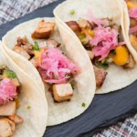 Al Carnitas Taco · Slow roasted Slagel farm pork belly, pickled red onions, cilantro, and roasted chile de Arbo...