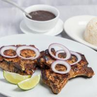Chuleta de Cerdo Frita · Marinated center cut pork chops and lightly fried. Served with white rice, black beans.
