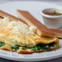 Tortilla de Espinaca Con Manchego · Spinach omelette with manchego cheese and pressed Cuban toast.