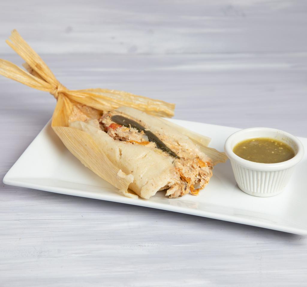 Tamal de Pollo y Rajas · Corn dough tamale stuffed with chicken and strips of jalapeno chiles, tomatillo avocado leaf and hoja santa sauce.