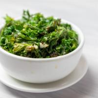 Couve a Mineira · Finely shredded kale sauteed with garlic.