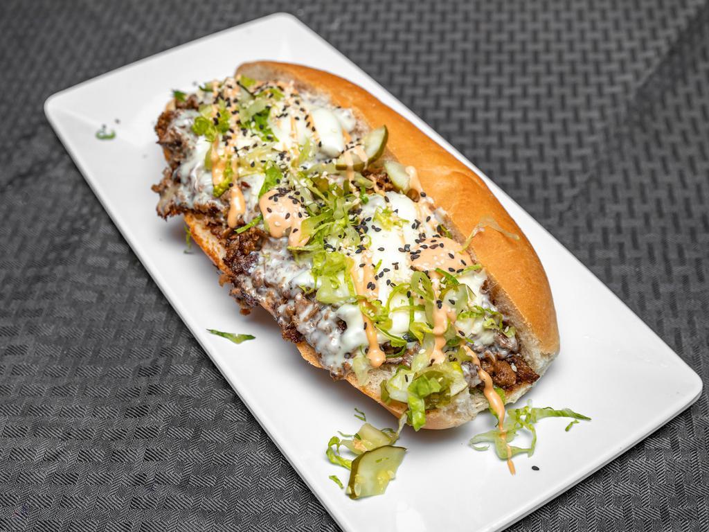 Big Max Cheesesteak · Shaved steak, American cheese, onions, pickles, remoulade, sesame seeds, lettuce, herbs, grinder roll.