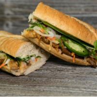 B3. Grilled Pork Banh Mi · Served with pickled daikon and carrots, butter, pate, cucumber, cilantro, green onion, jalap...