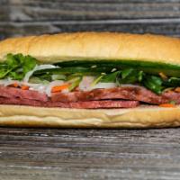 B5. Pork Sausage Banh Mi · Served with pickled daikon and carrots, butter, pate, cucumber, cilantro, green onion, jalap...