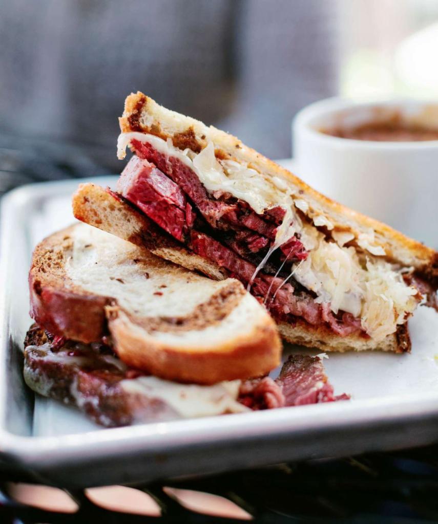 Smoked Corned Beef Reuben  · 14-hour smoked corned beef piled high on marbled rye, served with sauerkraut, 1000 Island dressing and Swiss cheese.