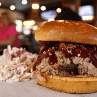 Pulled Pork Sandwich  · Smoked pulled pork piled high atop a toasted brioche bun served with pickles. Add coleslaw f...