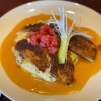 Blackened Tilapia · Cajun spiced tilapia served over wild rice with a lobster ginger sauce
