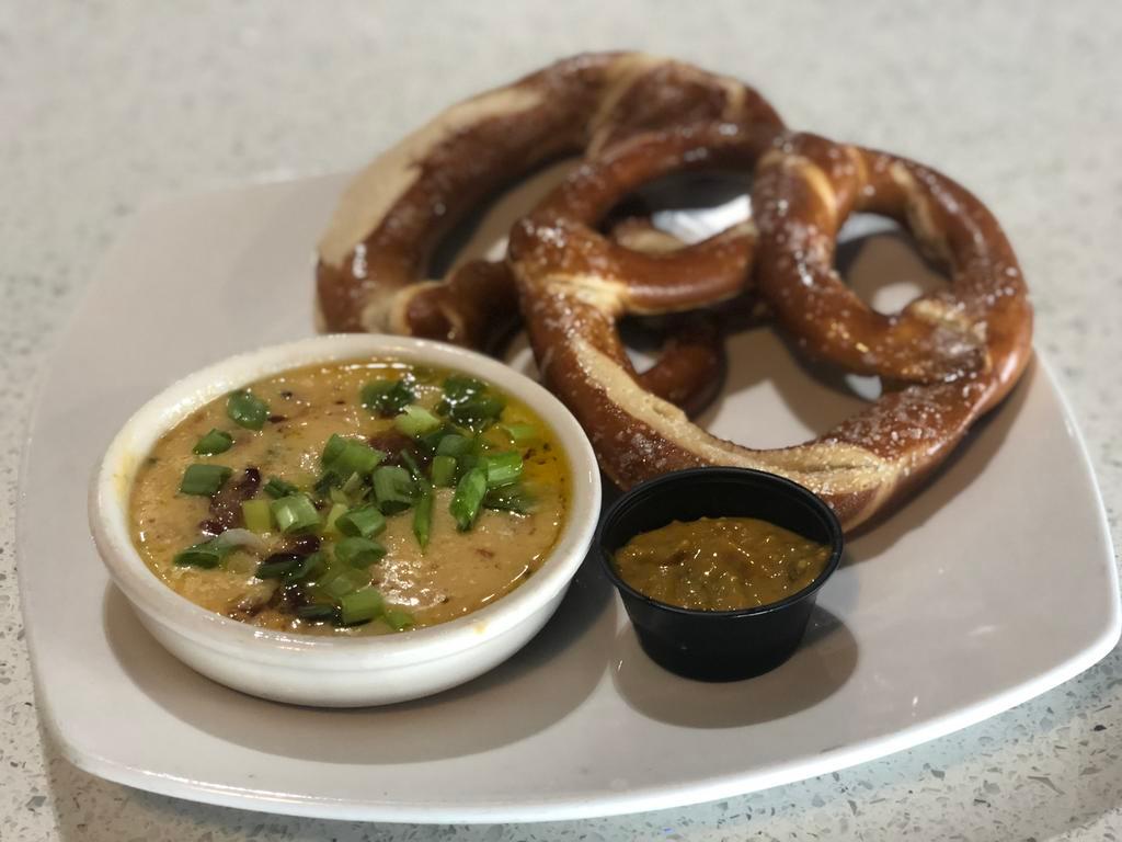 Pub Pretzels · Fresh baked salted pretzels, Karl Strauss red trolley ale beer cheese, sweet and spicy herb mustard.