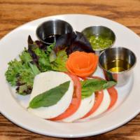 Caprese Salad · Fresh basil, tomatoes, and mozzarella with olive oil, balsamic vinegar, and pesto sides.