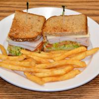 Smoked Turkey Club Sandwich · Smoked turkey, lettuce, tomatoes, and provolone cheese on multigrain bread with crispy fries.