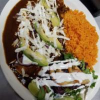 Enchiladas de Mole Dinner · Traditional Mexican sauce, 3 corn tortillas, rolled with chicken, topped with sour cream, ch...