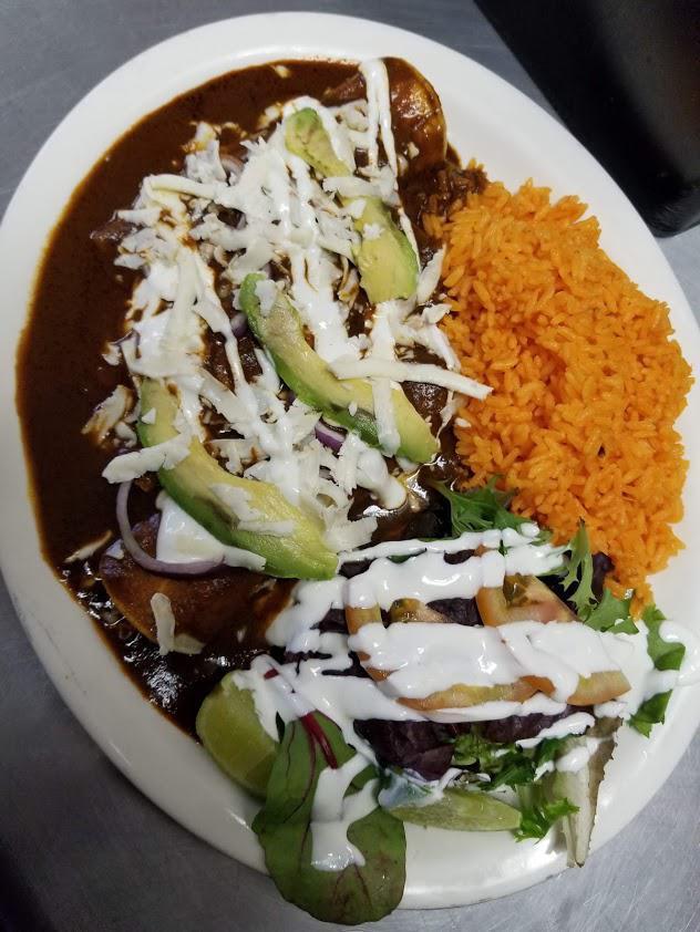Enchiladas de Mole Dinner · Traditional Mexican sauce, 3 corn tortillas, rolled with chicken, topped with sour cream, cheese and avocado. Served with side salad and rice.