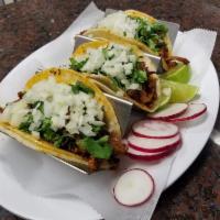 3 Tacos al Pastor · Marinated pork. 3 soft shell tacos with onions, cilantro and side of sauce.