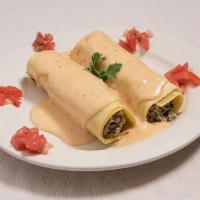 Cannelloni Florentine · Pasta tubes filled with ground veal, spinach and ricotta cheese topped with blush sauce.