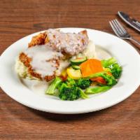 Chicken Fried Chicken · Fried chicken filet topped with brown sauce. Served with mashed potatoes and medley vegetabl...
